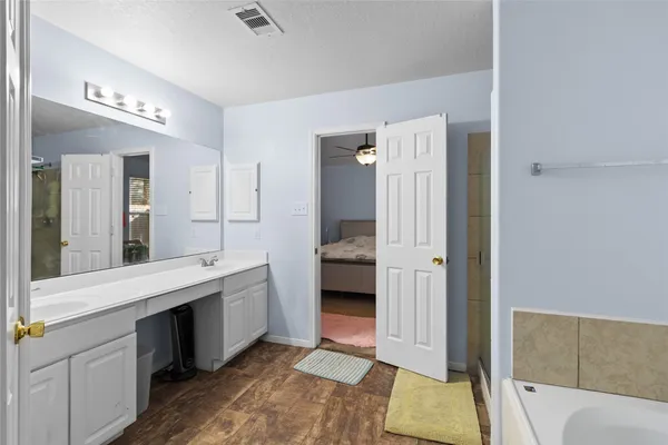 a spacious bathroom with a double vanity sink and a mirror