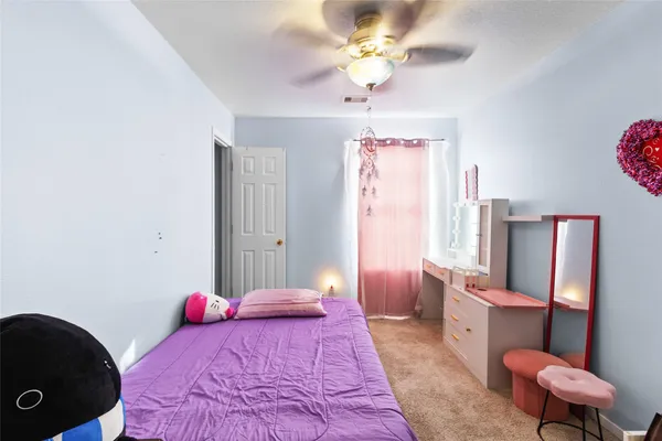 a bedroom with a bed dresser and a window