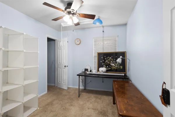 a view of workspace with a ceiling fan and a window