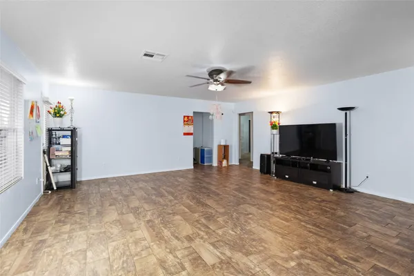 a view of a livingroom with furniture and a flat screen tv