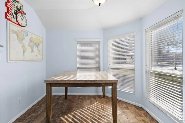 a view of a workspace with furniture and a window