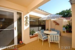 811 Reef Point Circle Naples, FL 34108 - Photo 2 of 8 a patio with table and chairs