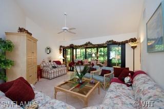 811 Reef Point Circle Naples, FL 34108 - Photo 3 of 8 a living room with furniture and a large window