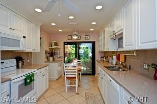 811 Reef Point Circle Naples, FL 34108 - Photo 5 of 8 a kitchen with a sink and cabinets