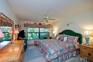 811 Reef Point Circle Naples, FL 34108 - Photo 6 of 8 a bed room with a bed and a large window