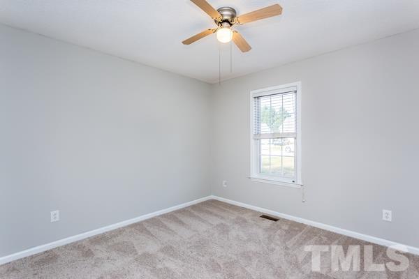 1925 Carthage Circle Raleigh, NC 27604 - Photo 11 of 15 an empty room with a window and a fan