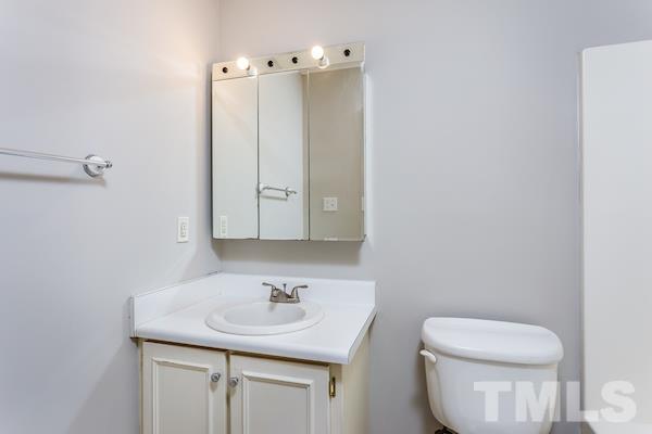 1925 Carthage Circle Raleigh, NC 27604 - Photo 12 of 15 a bathroom with a toilet sink and mirror
