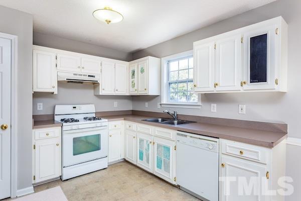 1925 Carthage Circle Raleigh, NC 27604 - Photo 5 of 15 a kitchen with stainless steel appliances granite countertop white cabinets sink and window