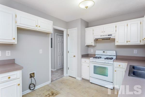 1925 Carthage Circle Raleigh, NC 27604 - Photo 6 of 15 a kitchen with a stove top oven sink and cabinets