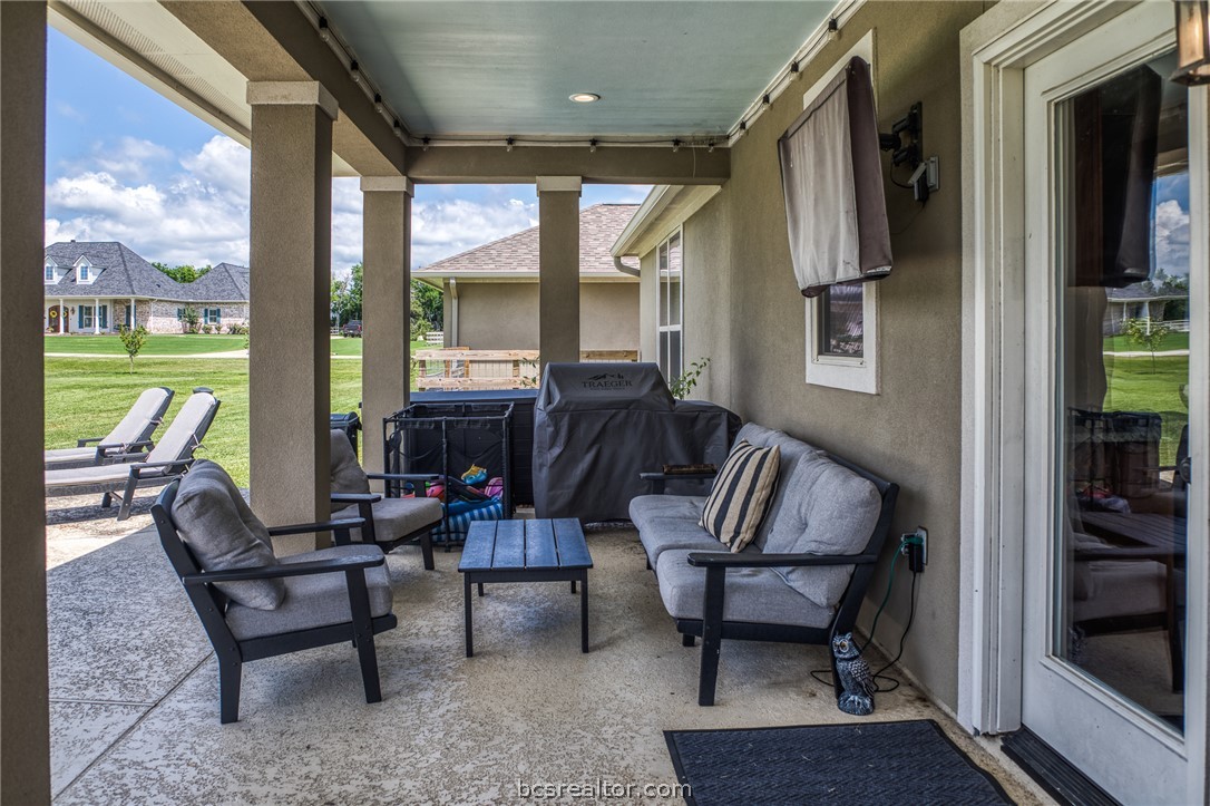 586 Ruby Drive Bellville, TX 77418 - Photo 37 of 50 a living room with furniture and a floor to ceiling window