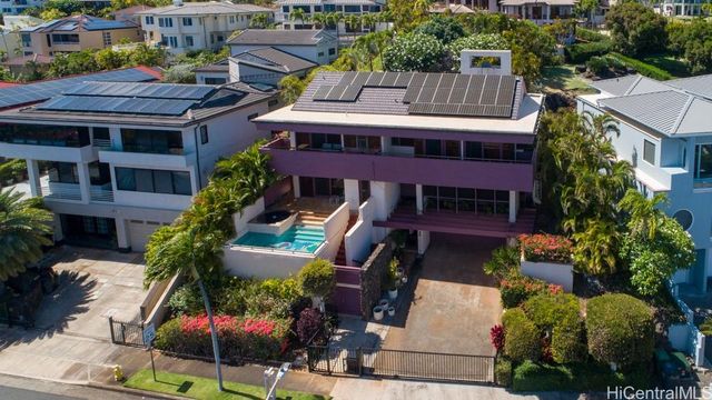 a front view of a house with garden and plants