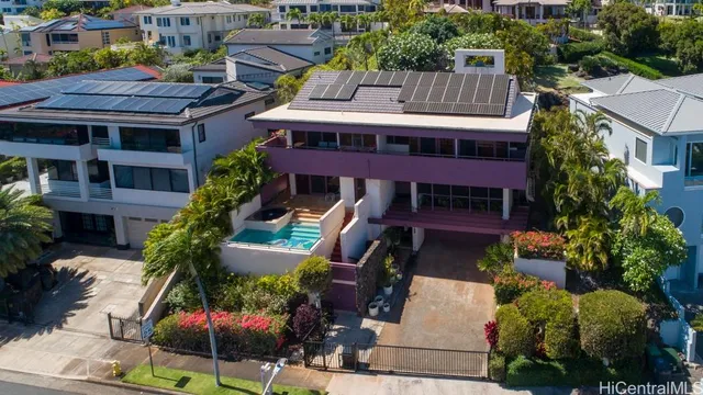 a front view of a house with garden and plants