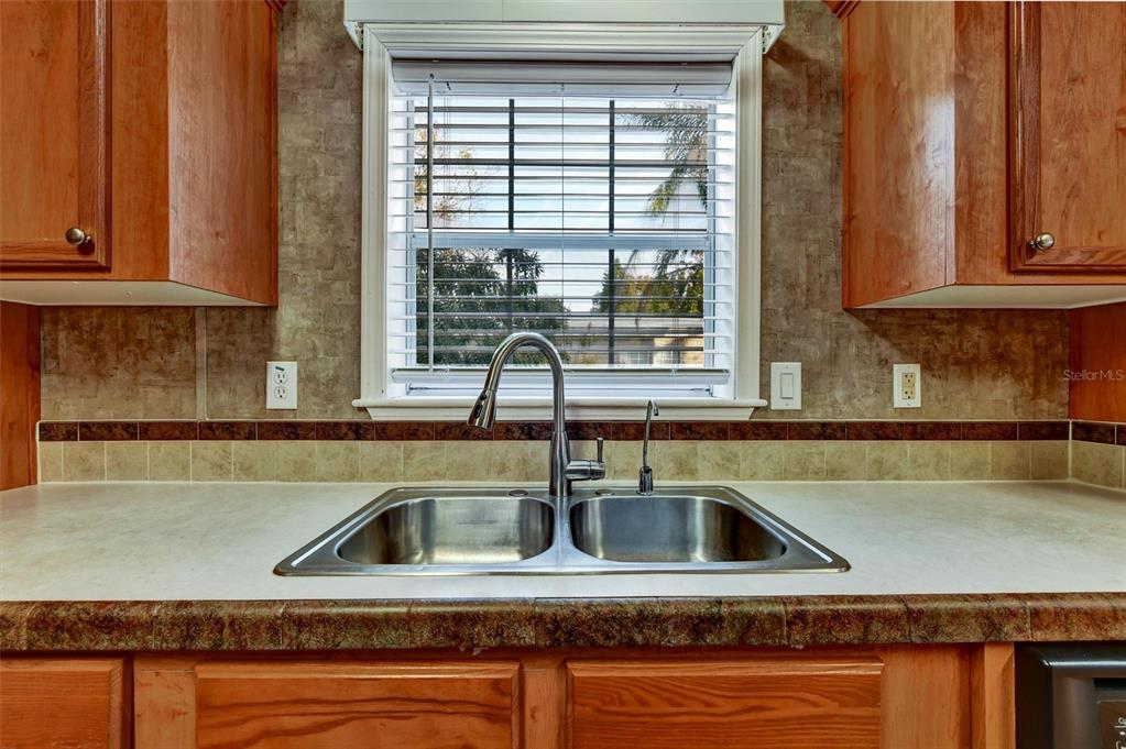312 Aristides Street Dunedin, FL 34698 - Photo 12 of 38 a kitchen with a sink and a window