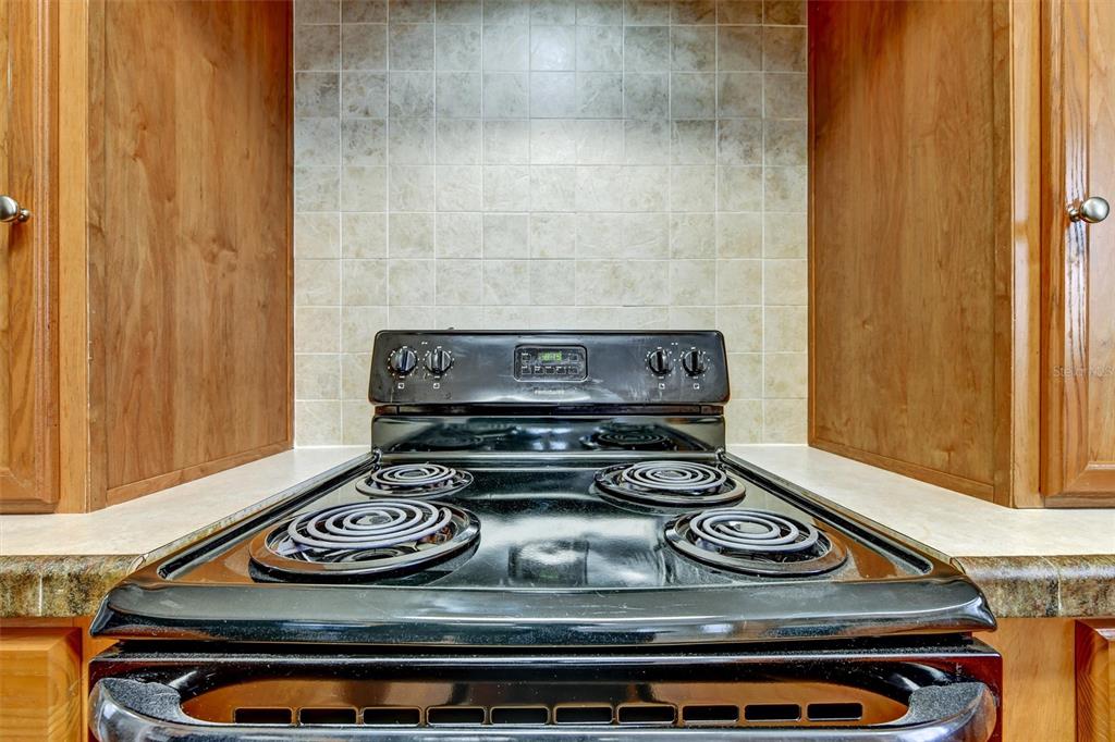 312 Aristides Street Dunedin, FL 34698 - Photo 13 of 38 a stove top oven sitting inside of a kitchen
