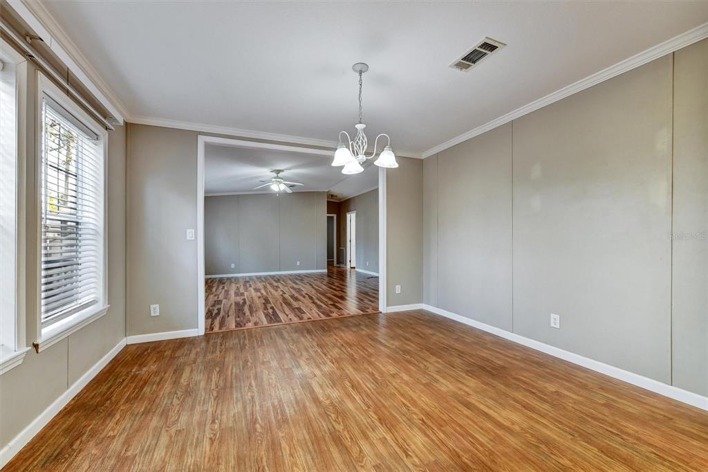 312 Aristides Street Dunedin, FL 34698 - Photo 14 of 38 a view of an empty room with wooden floor and a window