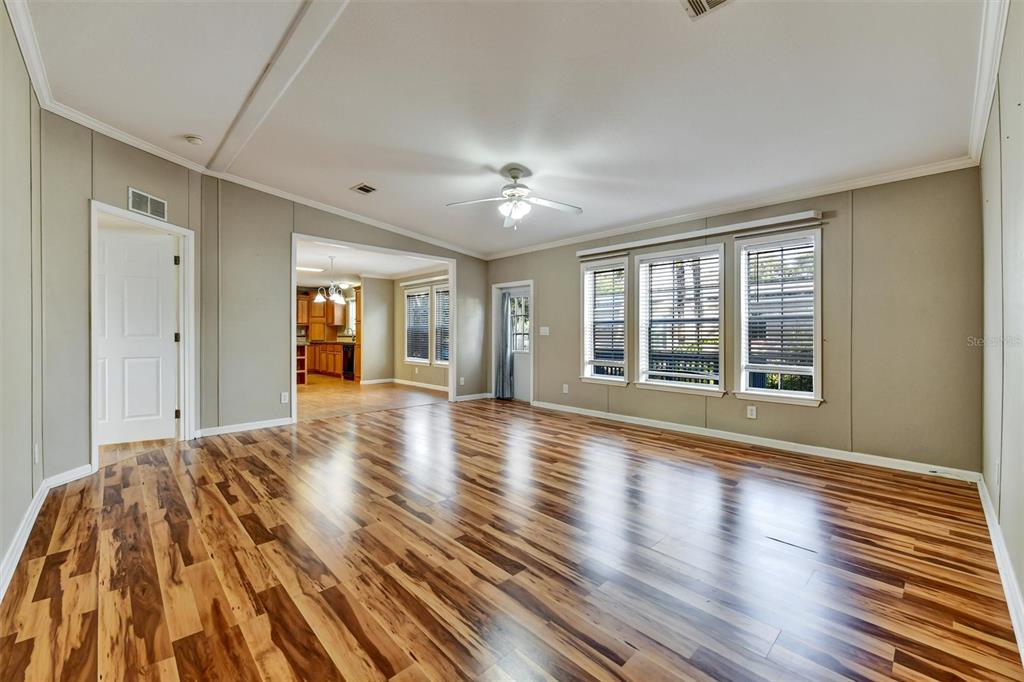 312 Aristides Street Dunedin, FL 34698 - Photo 18 of 38 a view of empty room with wooden floor and fan