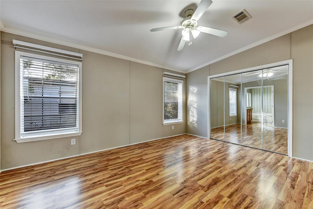 312 Aristides Street Dunedin, FL 34698 - Photo 19 of 38 a view of an empty room with window and chandelier fan