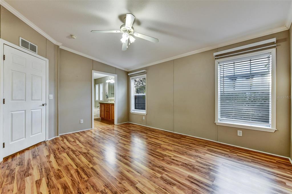 312 Aristides Street Dunedin, FL 34698 - Photo 20 of 38 a view of an empty room with a window and wooden floor