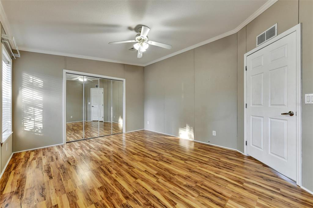 312 Aristides Street Dunedin, FL 34698 - Photo 21 of 38 a view of empty room with window and wooden floor