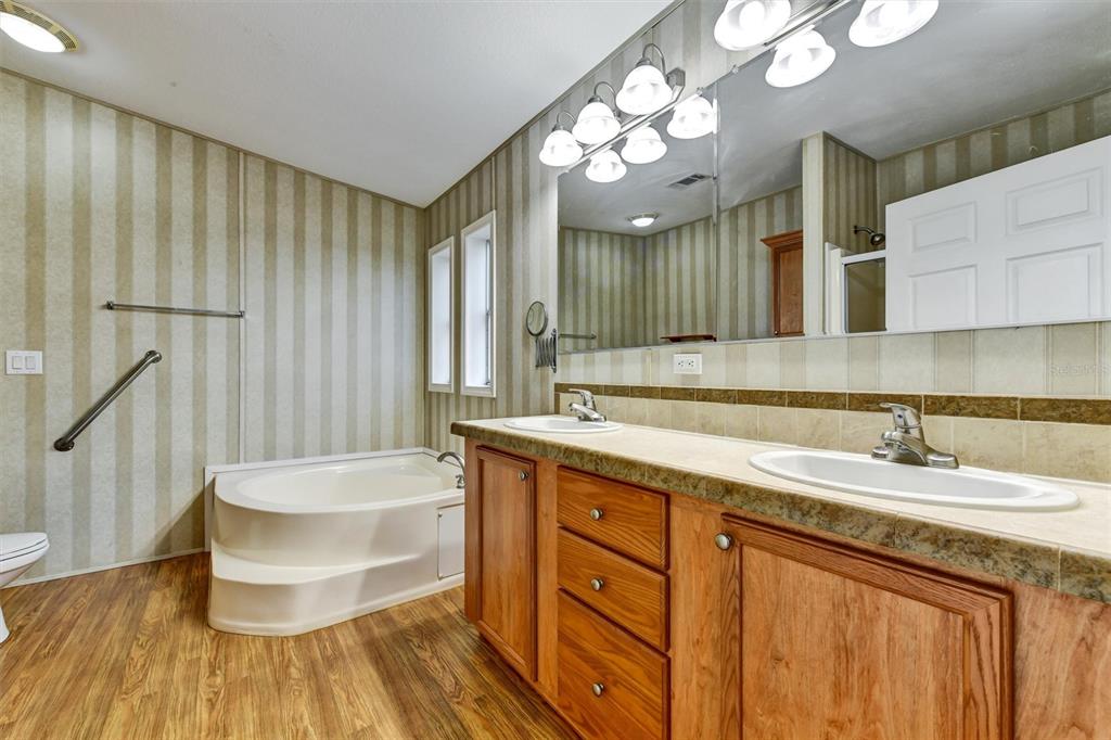 312 Aristides Street Dunedin, FL 34698 - Photo 22 of 38 a bathroom with a tub sink and mirror