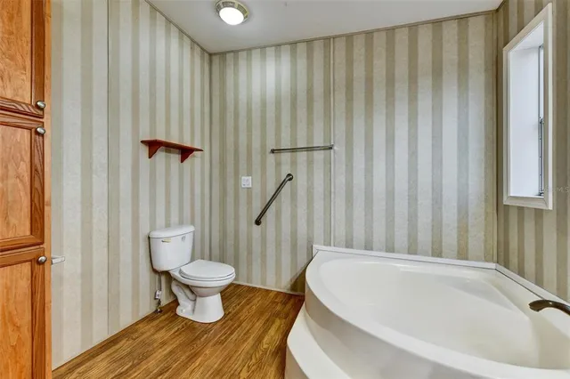 a bathroom with a tub sink and mirror