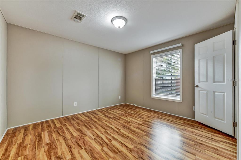 312 Aristides Street Dunedin, FL 34698 - Photo 26 of 38 a view of empty room with wooden floor