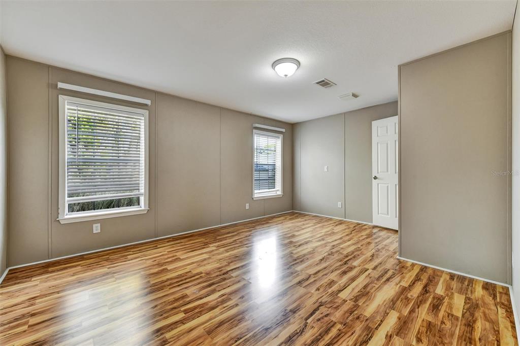312 Aristides Street Dunedin, FL 34698 - Photo 28 of 38 a view of an empty room with wooden floor and a window