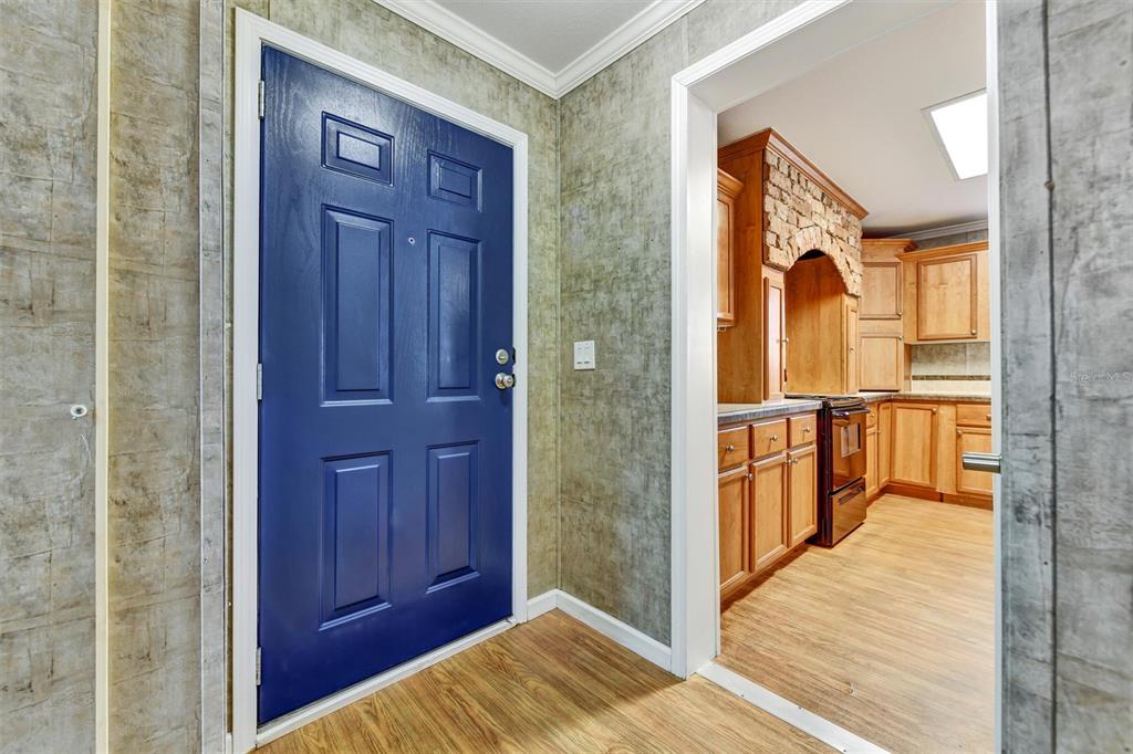 312 Aristides Street Dunedin, FL 34698 - Photo 3 of 38 a view of a hallway with wooden floor and entryway