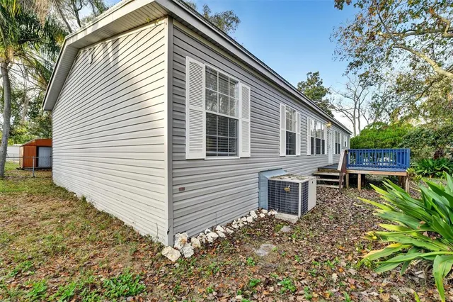 a view of a backyard with large trees