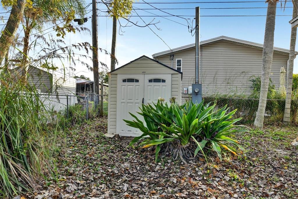 312 Aristides Street Dunedin, FL 34698 - Photo 35 of 38 a white house with a yard and plants