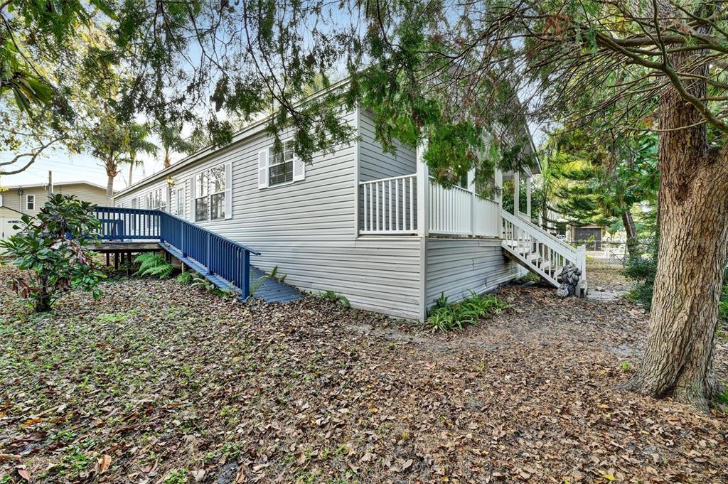 312 Aristides Street Dunedin, FL 34698 - Photo 36 of 38 a view of a house with a yard and large trees