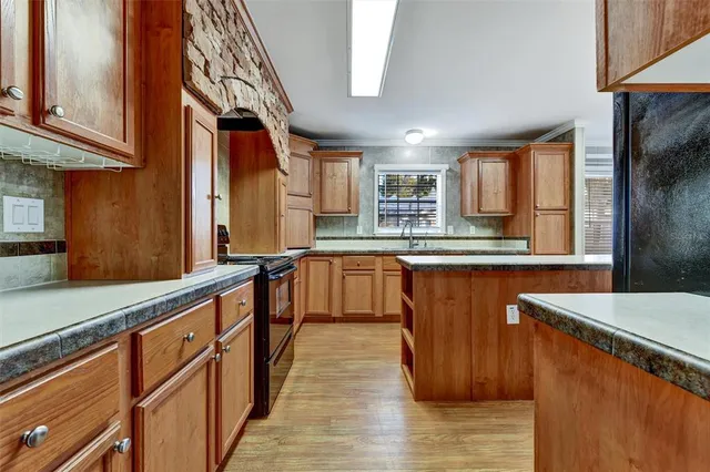 a kitchen with stainless steel appliances granite countertop a stove and a sink
