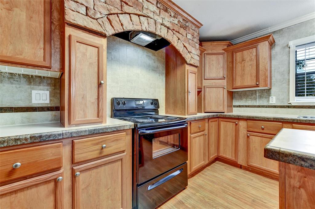 312 Aristides Street Dunedin, FL 34698 - Photo 6 of 38 a kitchen with stainless steel appliances granite countertop a stove and a sink