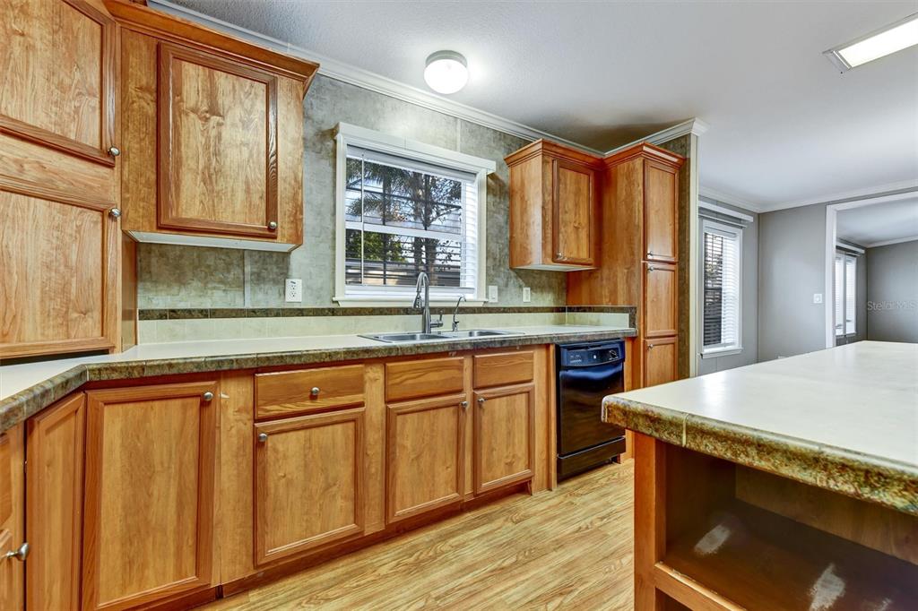312 Aristides Street Dunedin, FL 34698 - Photo 7 of 38 a kitchen with stainless steel appliances granite countertop wooden cabinets a sink and a granite counter tops