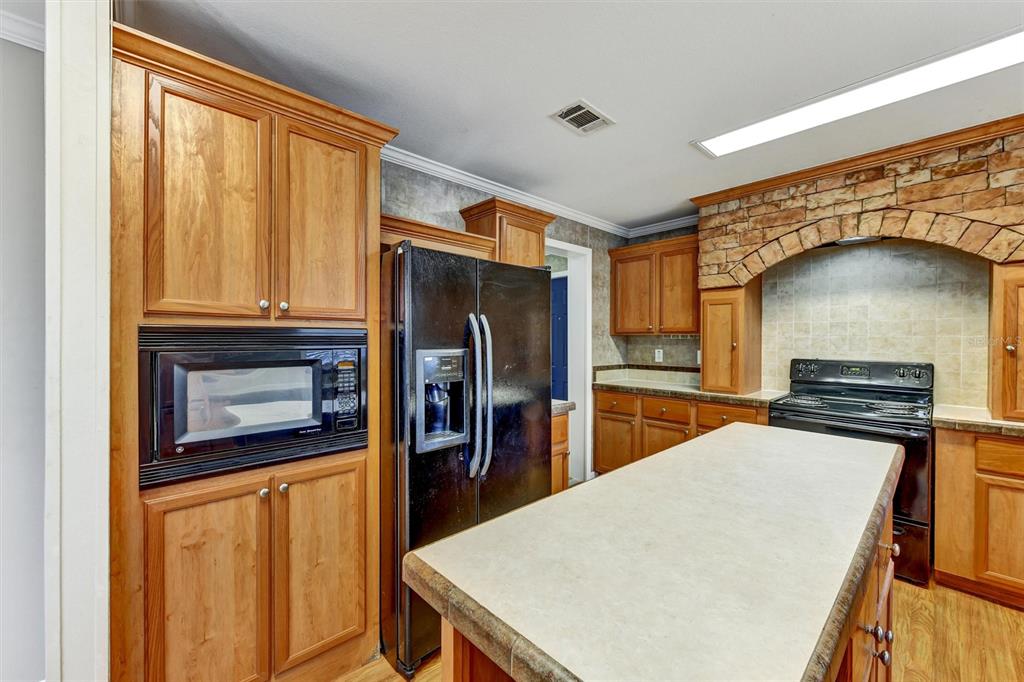 312 Aristides Street Dunedin, FL 34698 - Photo 10 of 38 a kitchen with stainless steel appliances a refrigerator and a stove top oven