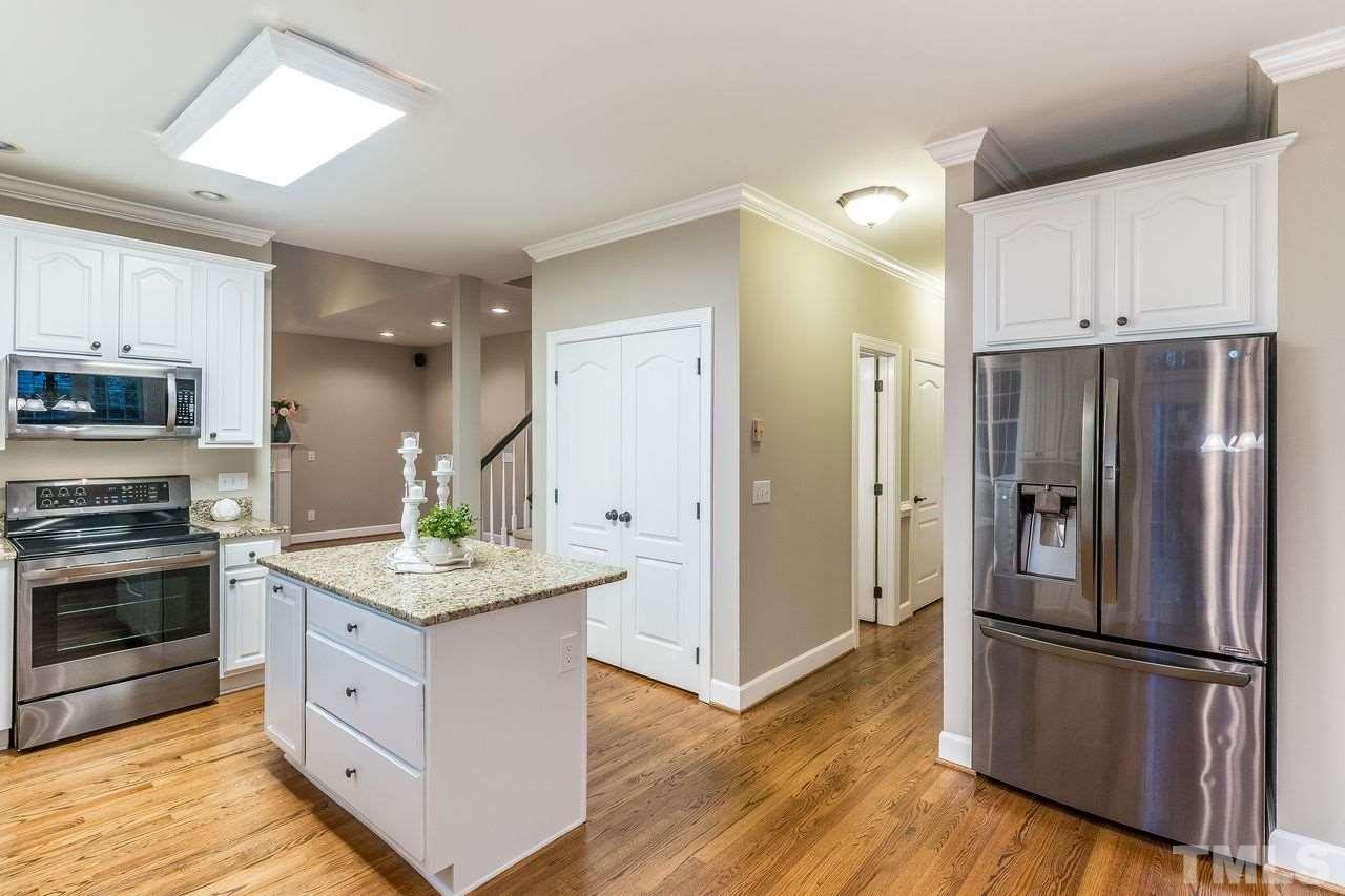 3712 Evander Way Raleigh, NC 27613 - Photo 3 of 13 Another view of the kitchen showing the GLEAMING HARDWOODS and spacious ISLAND!