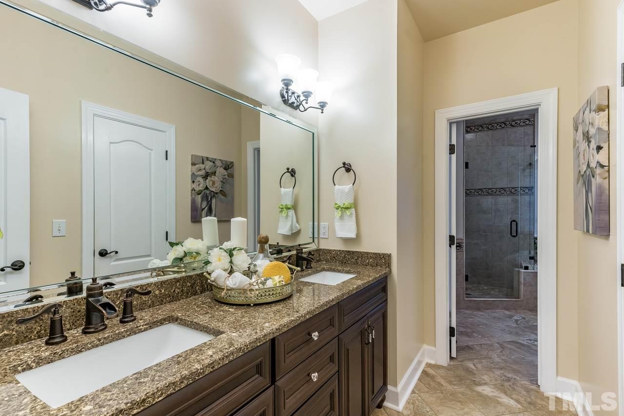 3712 Evander Way Raleigh, NC 27613 - Photo 6 of 13 Updated Owners Bath with GRANITE counter, soaking tub & large walk in TILE shower. HEATED TILE floors too!! There's lots of cabinet and closet/storage space!