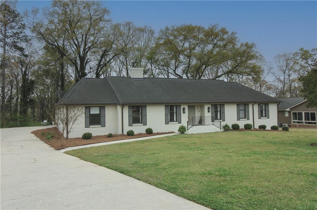 112 Maple Drive Cartersville, GA 30120 - Photo 1 of 105 a front view of a house with a garden and trees