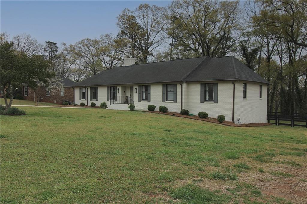 112 Maple Drive Cartersville, GA 30120 - Photo 4 of 105 a front view of house with a garden and trees