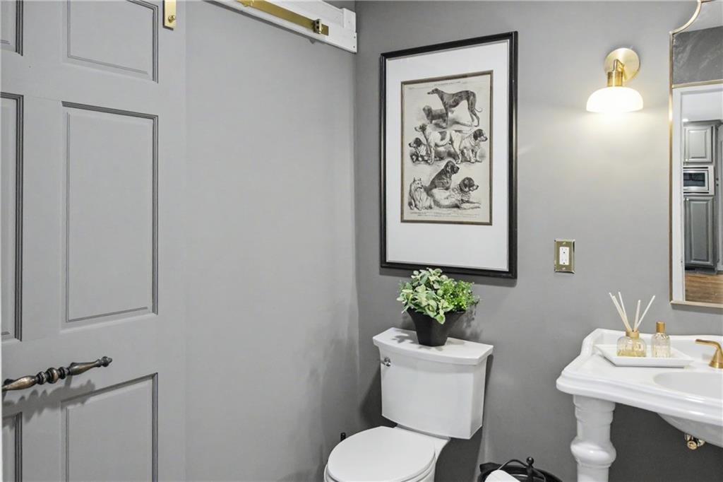 112 Maple Drive Cartersville, GA 30120 - Photo 60 of 105 a bathroom with a toilet a sink and a mirror