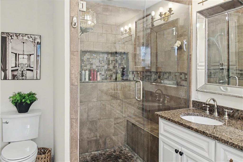 112 Maple Drive Cartersville, GA 30120 - Photo 70 of 105 a bathroom with a granite countertop sink a toilet and shower