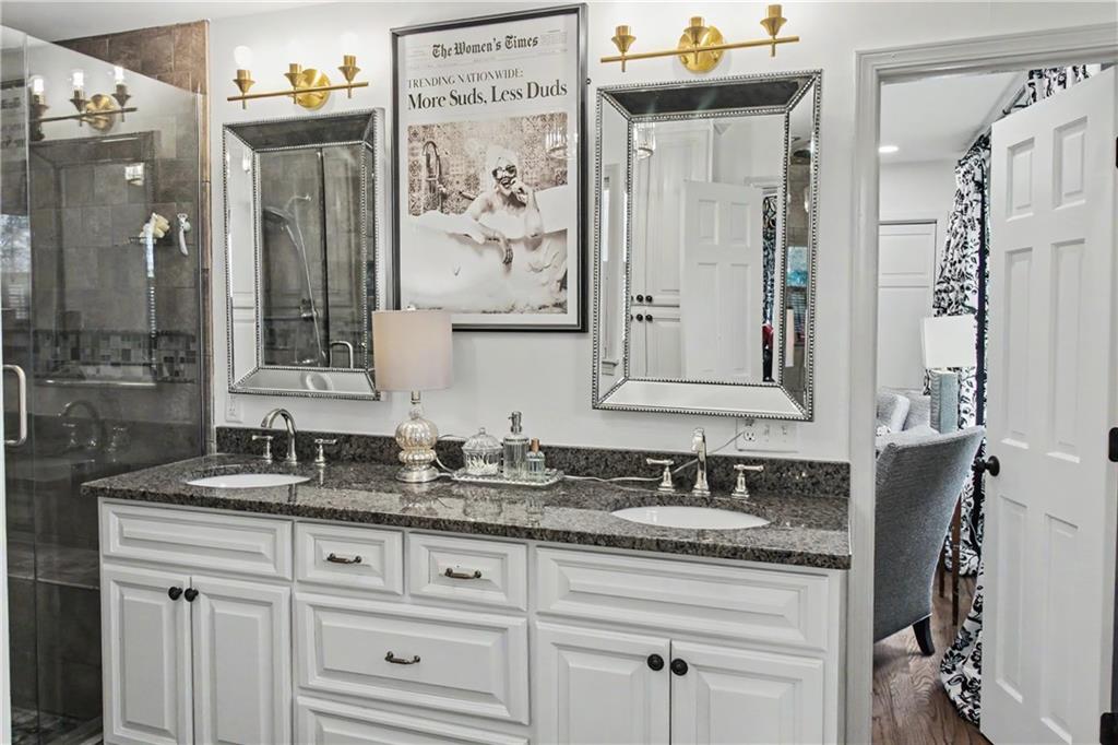 112 Maple Drive Cartersville, GA 30120 - Photo 73 of 105 a bathroom with cabinets and mirror