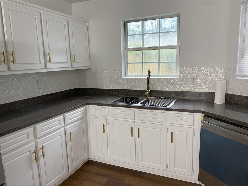 1754 Soapstone Court Decatur, GA 30034 - Photo 7 of 19 a kitchen with white cabinets and a sink