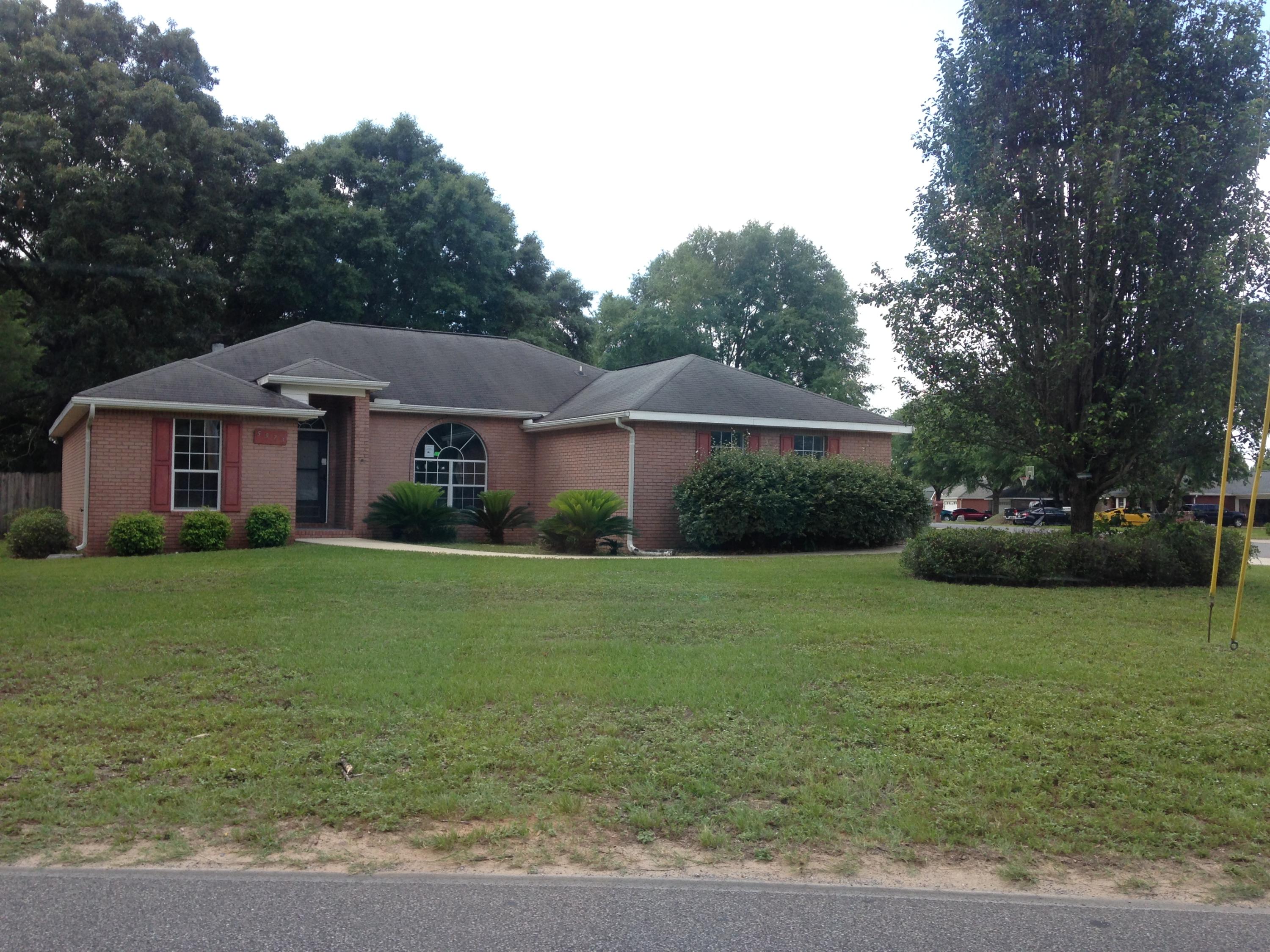 5973 Old Bethel Road Crestview, FL 32536 - Photo 1 of 18 a front view of a house with garden