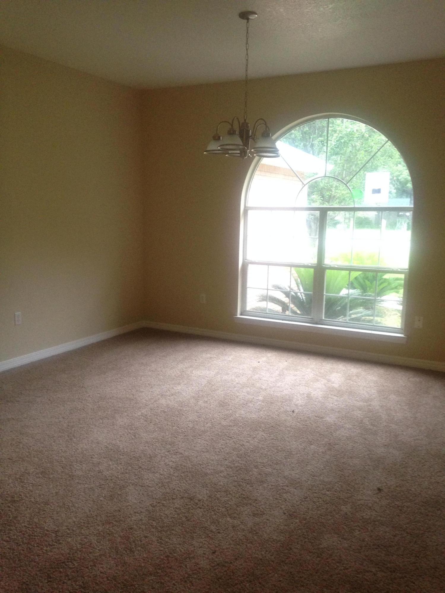 5973 Old Bethel Road Crestview, FL 32536 - Photo 5 of 18 an empty room with a window and chandelier