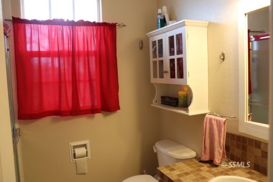 1624 South Farragut Street Ridgecrest, CA 93555 - Photo 19 of 43 a bathroom with a toilet and sink