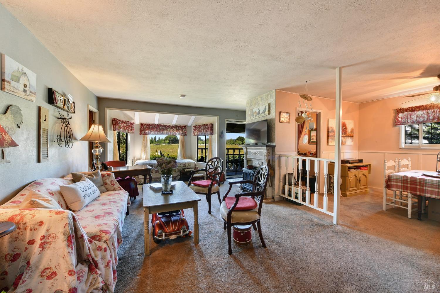148 Millbrae Avenue Santa Rosa, CA 95407 - Photo 13 of 29 a living room with furniture and a dining table with kitchen view
