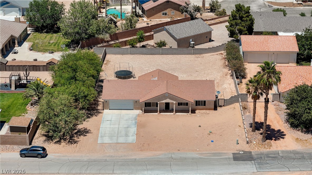 1272 Liston Avenue Logandale, NV 89021 - Photo 49 of 61 A desert oasis with a spacious front yard and convenient attached garage.