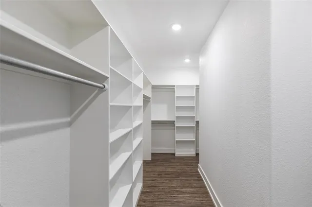 a view of walk in closet with empty racks