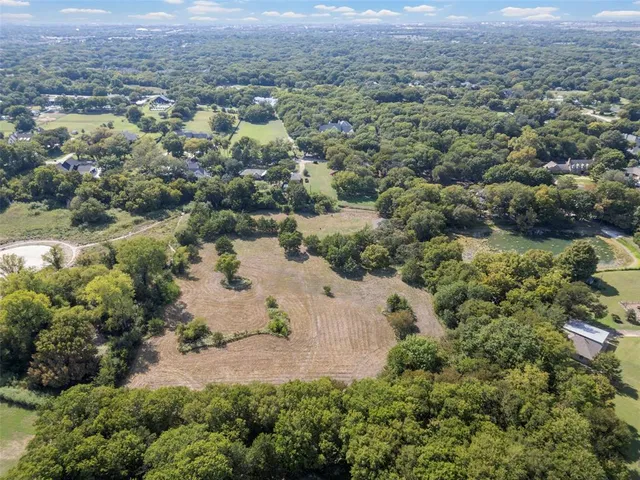 an aerial view of a houses with a yard